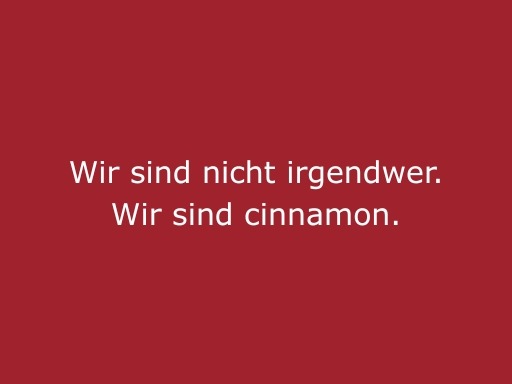 Roter Hintergrund mit beiger Schrift „Wir sind nicht irgendwer. Wir sind cinnamon“, starkes Statement für cinnamon Eventpersonal, Hospitality und Promotion Einsätze in Freiburg